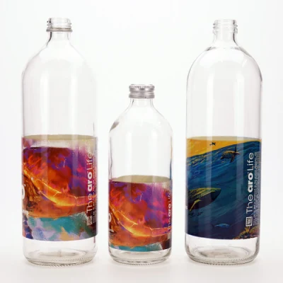 Vista 500ml 1000ml Botella de vidrio de agua redonda Flint con impresión de etiquetas